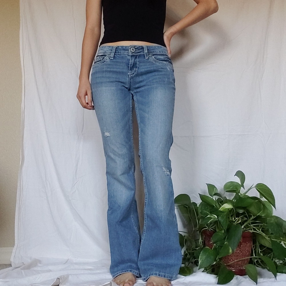 Medium-light wash lightly distressed bootcut jeans